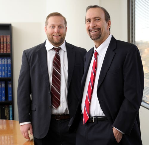 Attorneys Anthony J. Viorst and David Chambers smiling in the office